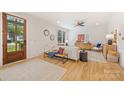 Inviting living room with light hardwood floors, contemporary furnishings, natural light, and a cozy atmosphere at 2117 Roslyn Ave, Charlotte, NC 28208