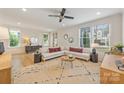 Bright living room with hardwood floors, large windows, recessed lighting, modern furniture, and stylish decor at 2117 Roslyn Ave, Charlotte, NC 28208