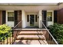 Inviting brick front entrance with black iron railings and a storm door for a classic aesthetic at 2410 Armstrong Park Dr, Gastonia, NC 28054