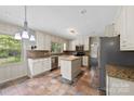 Bright eat-in kitchen featuring an island, stainless steel appliances, and granite countertops at 2410 Armstrong Park Dr, Gastonia, NC 28054