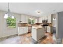 Bright kitchen featuring an island, stainless steel appliances, and granite countertops at 2410 Armstrong Park Dr, Gastonia, NC 28054