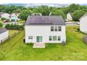 Aerial view of home with solar panels, spacious backyard, and lush green grass at 3038 Old Ironside Dr, Charlotte, NC 28213