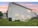 The back of the house has many windows and a sliding glass door leading to the yard at 3038 Old Ironside Dr, Charlotte, NC 28213