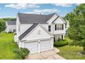 Traditional two-story home with attached two-car garage and well-kept lawn at 3038 Old Ironside Dr, Charlotte, NC 28213