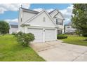 Charming two-story home boasts a two-car garage and well-maintained landscaping at 3038 Old Ironside Dr, Charlotte, NC 28213