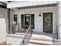 Cozy front porch with seating area and decorative wreath on the front door, creating a welcoming entrance at 317 Marietta Rd, Mooresville, NC 28117