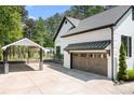 Attached garage and carport with stone columns and a wide driveway, offer ample parking space at 317 Marietta Rd, Mooresville, NC 28117