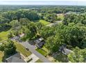 An aerial view of a home surrounded by lush greenery and a tranquil neighborhood at 319 N Central Ave, Locust, NC 28097