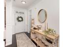 Charming foyer showcasing a decorative table, round mirror, and inviting entryway at 3267 Lock Erne Ave, Kannapolis, NC 28081