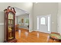 Bright foyer with hardwood floors, a decorative front door, and a view into the dining room at 34843 Ellis Spring Ct, Albemarle, NC 28001