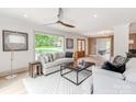 Bright living room with large window views, elegant furnishings, and a modern ceiling fan at 3501 Providence Rd, Charlotte, NC 28211