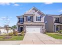 Charming two-story home with stone accents, well-maintained lawn, and a two-car garage at 356 Runner Stone Ln, Fort Mill, SC 29715