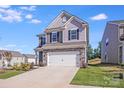 Charming two-story home with stone accents, well-maintained lawn, and a two-car garage at 356 Runner Stone Ln, Fort Mill, SC 29715