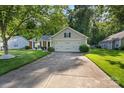 Charming single-story home with a well-manicured lawn, mature trees, and a two-car garage, creating great curb appeal at 3604 Braefield Dr, Indian Trail, NC 28079