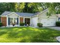 Beautiful single-Gathering home with a well-maintained lawn and mature landscaping offering great curb appeal at 3604 Braefield Dr, Indian Trail, NC 28079