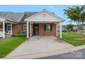Exterior of a charming brick home with a covered carport and well-maintained landscaping at 3951 Jasmine Ln, Denver, NC 28037