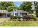 Charming blue home with lush landscaping and a well-manicured front yard with black shutters at 430 Sells Rd, Salisbury, NC 28144