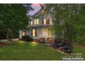 Charming two-story home featuring a covered front porch with classic white columns and well-manicured lawn at 5022 Saybrook Dr, Harrisburg, NC 28075