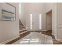Welcoming foyer with a front door, hardwood floors, a staircase, and a decorative rug at 5128 Oakhaven Ln, Fort Mill, SC 29708