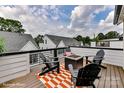 Relaxing deck featuring a cozy fire pit, stylish chairs, and a patterned outdoor rug at 514 Lockwood Creek Dr # 30, Charlotte, NC 28208