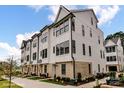Charming exterior view of a multi-story townhouse featuring a brick foundation and ample windows at 516 Lockwood Creek Dr # 31, Charlotte, NC 28208