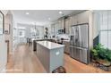 Open kitchen with stainless steel appliances, gray cabinets, and a central island at 518 Lockwood Creek Dr # 32, Charlotte, NC 28208