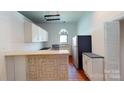 Bright kitchen featuring white cabinets, an island, and hardwood floors at 600 E 35Th St, Charlotte, NC 28205