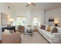 Cozy living room with plush seating, large windows, hardwood floors, and stylish decor for a relaxed atmosphere at 721 Governor Morrison St # 520, Charlotte, NC 28211