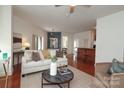 Open living area with a white couch, modern decor, a dining space, a breakfast bar, and wood floors at 721 Governor Morrison St # 520, Charlotte, NC 28211