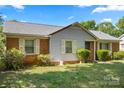 Inviting single-story home with brick and siding exterior, neat shrubs, and a well-maintained front yard at 728 Dedmon Dr, Charlotte, NC 28216