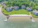 Aerial view of lakefront condos with a private beach and boat docks at 803 Lake Club Dr, Rock Hill, SC 29732