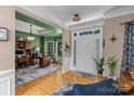 Spacious foyer features hardwood floors, neutral walls, and an inviting view into a study area at 8211 Abbottsgate Ln, Charlotte, NC 28269