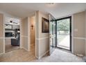 Inviting foyer with tile flooring, neutral paint, and views into the living spaces at 8525 Castlekeep Rd # 26, Charlotte, NC 28226