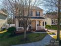 Charming two-story home featuring a welcoming front porch and meticulously maintained landscaping at 8532 Westmoreland Lake Dr, Cornelius, NC 28031