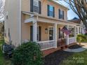 Charming two-story home with a welcoming front porch and well-maintained landscaping at 8532 Westmoreland Lake Dr, Cornelius, NC 28031