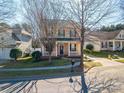 Charming two-story home featuring a welcoming front porch and meticulously maintained landscaping at 8532 Westmoreland Lake Dr, Cornelius, NC 28031