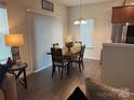 A cozy dining area features modern chairs and a decorative chandelier at 9340 Grand Valley Dr, Charlotte, NC 28213