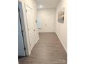 Inviting hallway with durable wood-look flooring and neutral paint creates a welcoming entrance at 9340 Grand Valley Dr, Charlotte, NC 28213