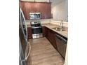 A kitchen featuring granite countertops, stainless steel appliances, and wood cabinets at 9340 Grand Valley Dr, Charlotte, NC 28213