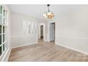 Bright dining room with hardwood floors and classic chandelier at 9640 Heartwood Ln, Mint Hill, NC 28227