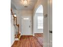 Inviting entryway featuring hardwood floors, staircase, and archway to living space at 975 Copperstone Ln, Fort Mill, SC 29708