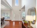Grand foyer with soaring ceilings, gleaming hardwood floors, and abundant natural light at 10205 Alouette Dr, Waxhaw, NC 28173