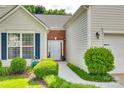 Close up of the well maintained front yard and white front door at 1301 Cool Mist Ct, Indian Land, SC 29707