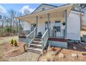 Inviting front porch with gray railings and steps, complemented by fresh landscaping at 1339 Hill St, Albemarle, NC 28001