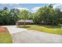 Long driveway leading up to a brick home surrounded by lush greenery and a well-maintained lawn at 1513 White Ridge Dr, Rock Hill, SC 29732