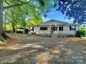 Single-story home featuring a covered front porch with swing and ample parking at 16603 Nc Hwy 73 Hwy, Albemarle, NC 28001