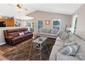 Spacious living room with hardwood floors, gray sofas, a brown leather sofa, and an area rug at 174 Perrin Dr, Mooresville, NC 28117