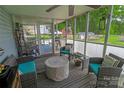 Enjoy the outdoors bug-free on this screened-in porch with comfortable seating and a view of the backyard at 174 Perrin Dr, Mooresville, NC 28117
