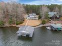 Stunning lakefront property with a private boathouse and beautifully landscaped grounds at 192 Diana Dr, Mount Gilead, NC 27306