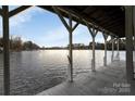 Spacious boathouse with ample docking space and serene lake views on a sunny day at 192 Diana Dr, Mount Gilead, NC 27306